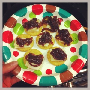 Crackers topped with aged cheddar (some with a slice of apple, too) and onion jam.
